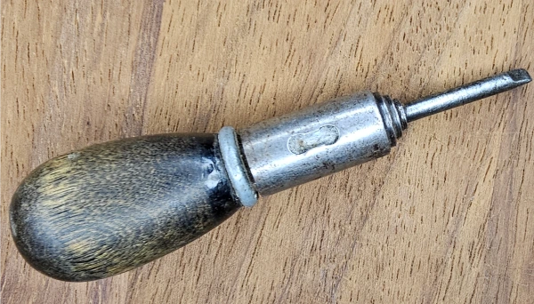 A vintage screwdriver that carries the marks of a lifetime of work.